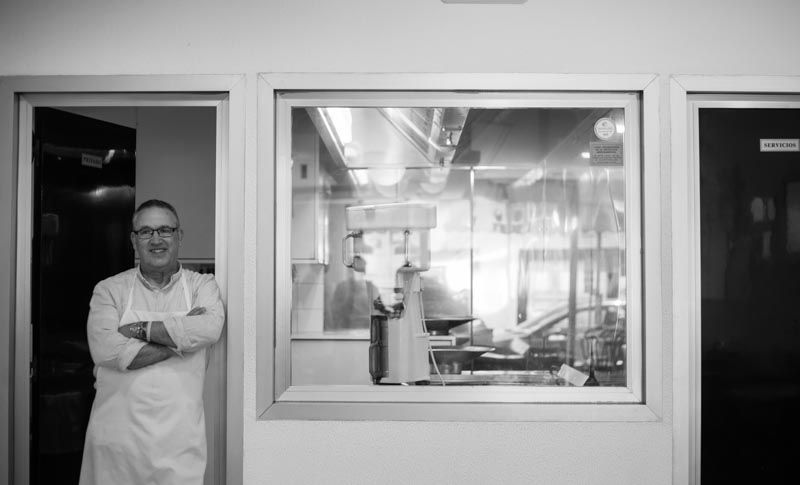 Rafael apoyado en la entrada de su 'laboratorio' de churros (Fotografía: Alicia Seoane)